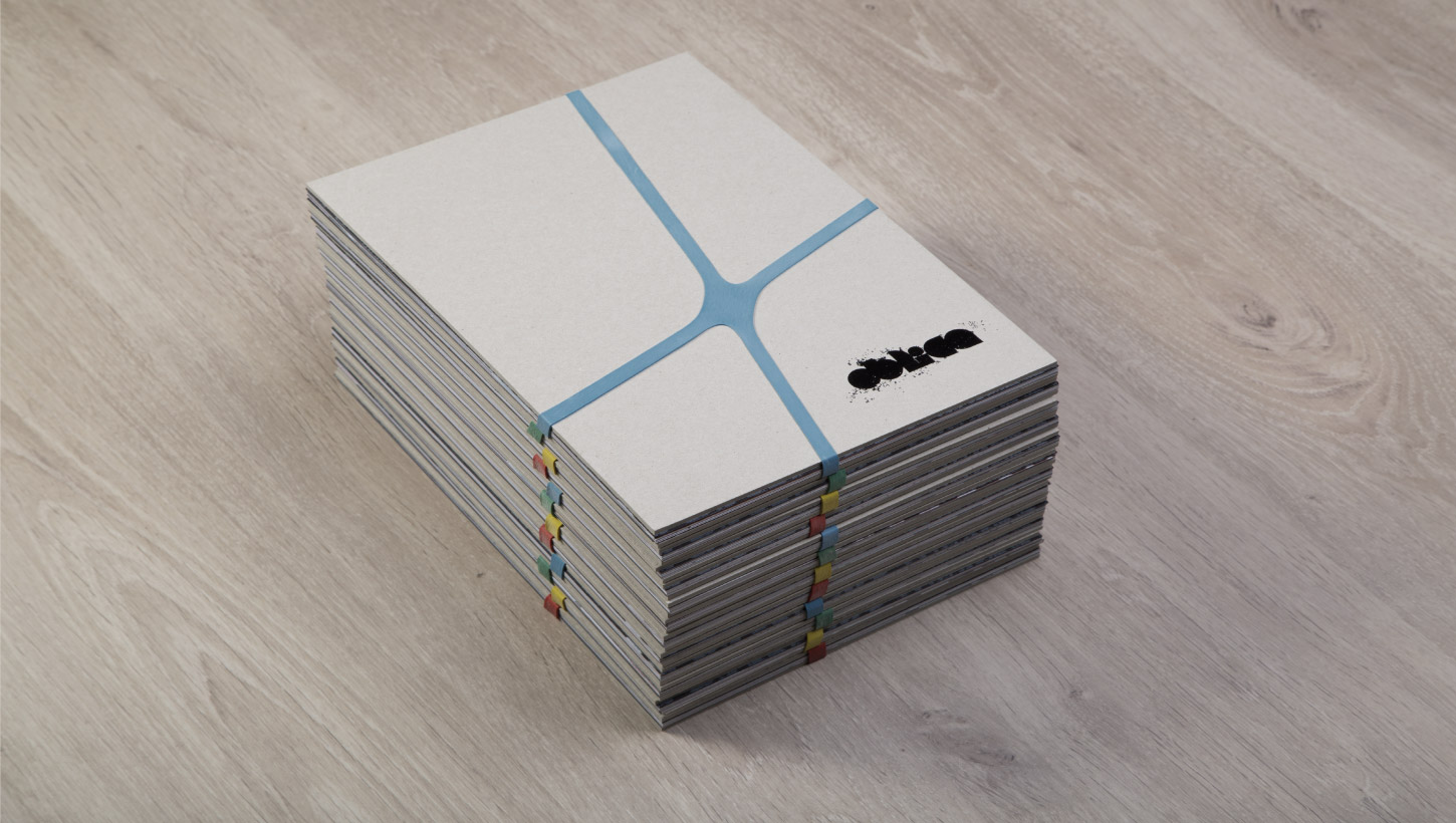 Oblica brochure stacked with rubber band
