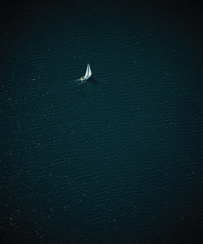 osprey photography single sailing boat in ocean