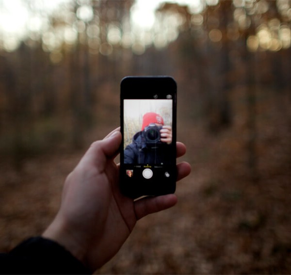 hand holding phone with camera on screen